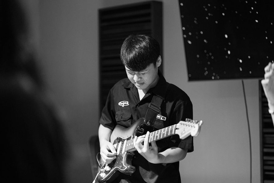 A teen playing guitar
