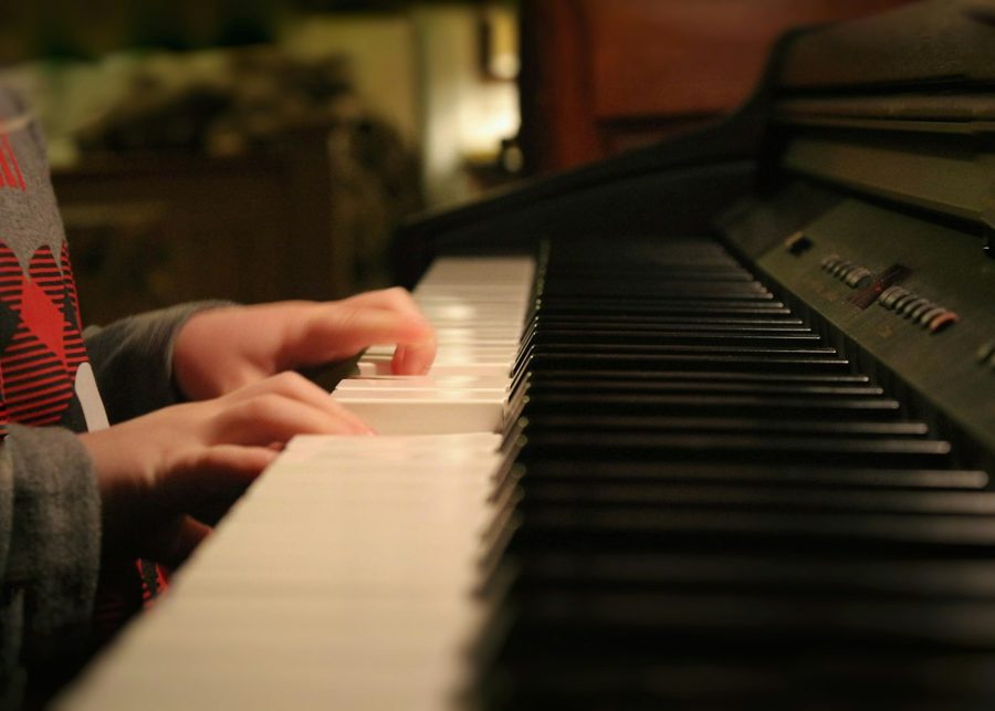Hands playing a piano